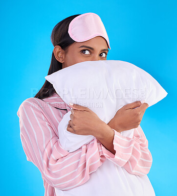 Buy stock photo Comfy, bedtime and a woman hugging a pillow isolated on a blue background in a studio. Relax, rest and an Indian girl ready for sleep, napping or night rest and thinking of sleeping on a backdrop