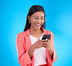 Happy business woman, phone and social media in surprise for deal, discount or online sale against a blue studio background. Excited creative female on smartphone smiling for communication or startup