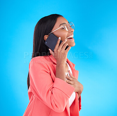 Buy stock photo Happy business woman, phone call and laughing for funny joke, meme or conversation against a blue studio background. Female employee laugh, humor and talking on mobile smartphone in fun discussion