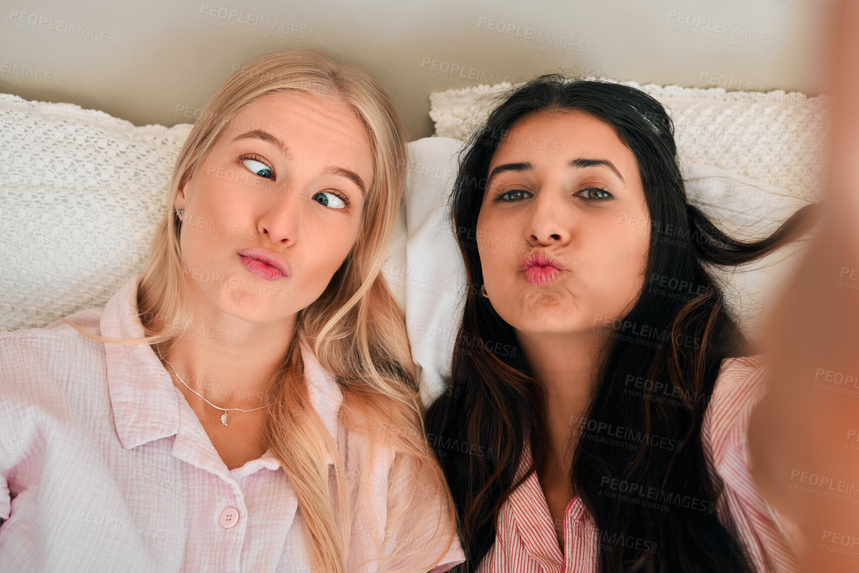 Buy stock photo Funny, playful and portrait of women with a selfie for a memory, friendship or comic together. Goofy, silly and friends taking a photo in the bedroom during a sleepover being crazy and joyful