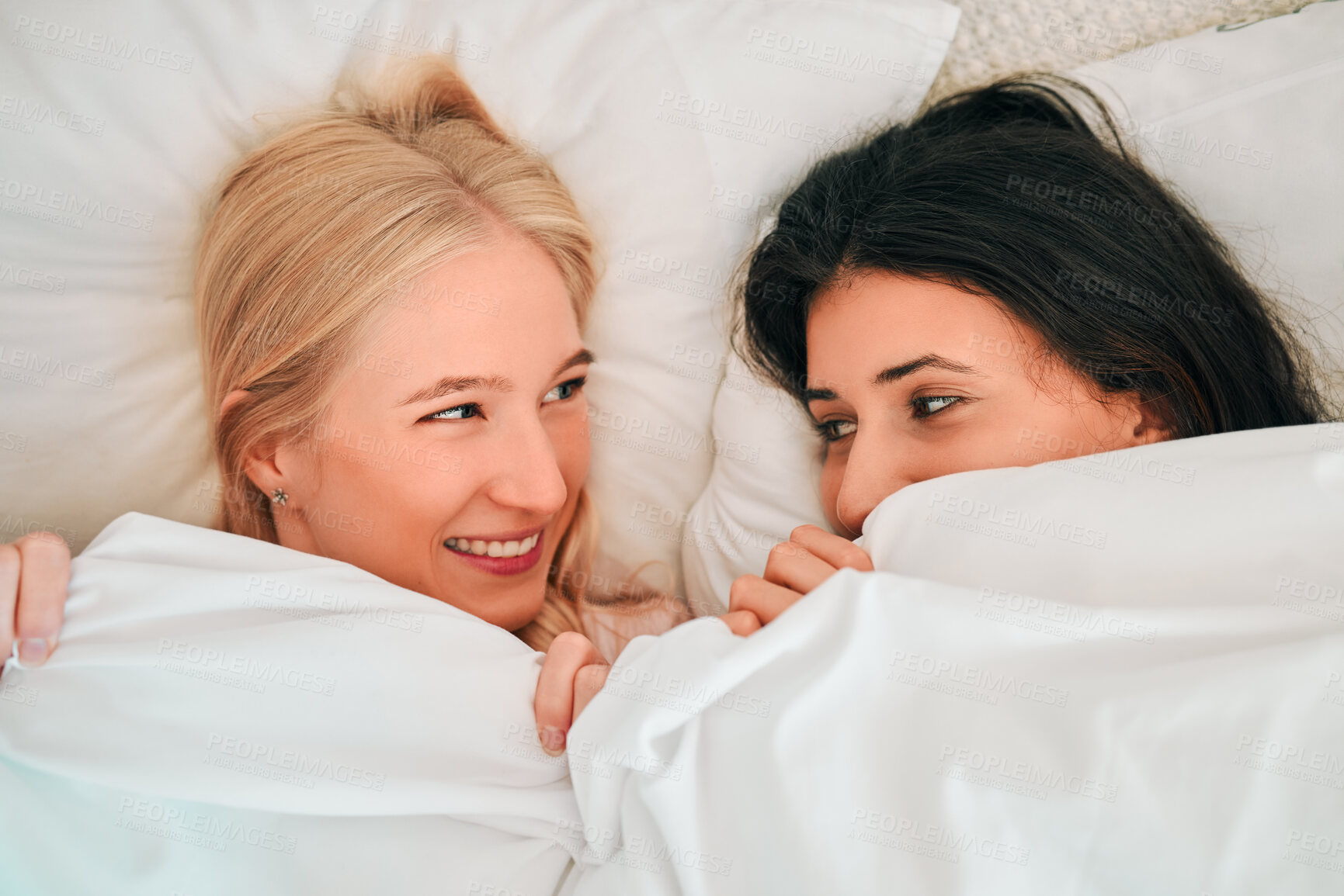 Buy stock photo Love, above and lesbian couple in bed, waking up and bonding in their home together. Lgbt, gay and happy women sharing romance, relationship and sweet moment in a bedroom, in love and content