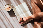 Notebook, writing and woman hands with coffee for ideas, inspiration and creativity on floor above in sunshine. Creative person with latte for mindfulness, healing notes or self care goals of writer