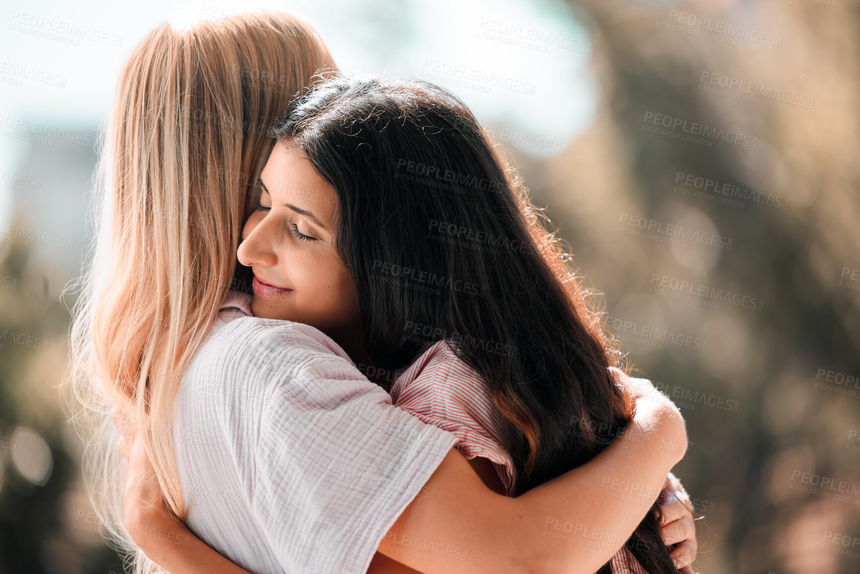 Buy stock photo Woman friends, hug and reunion outdoor in park, garden or backyard with love, care and bonding in summer. Women, embrace and happiness for meeting, welcome and support in sunshine for solidarity