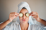 Self care, skincare and woman with cucumber on her face for a organic, cosmetic and natural skin routine. Beauty, vegetable and female doing a spa facial treatment for self love and to relax at home.