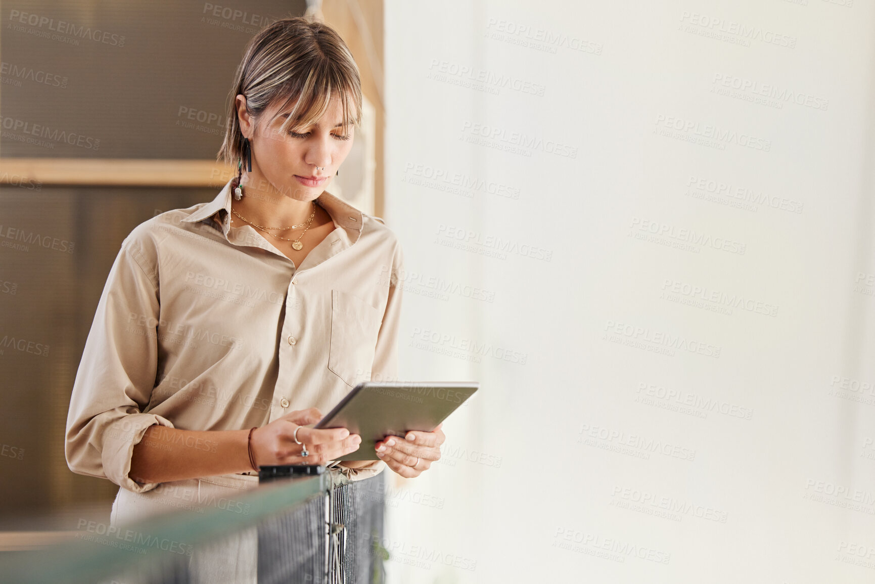 Buy stock photo Modern office, woman with tablet standing and reading email, website or checking social media news. Digital information, business research and online content, businesswoman on web search in workplace