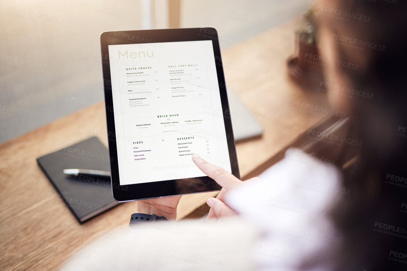 Buy stock photo Above person, menu and tablet in cafe for ordering food, meal and lunch on technology. Closeup of restaurant customer, screen and digital options on app of choice, selection and online in coffee shop