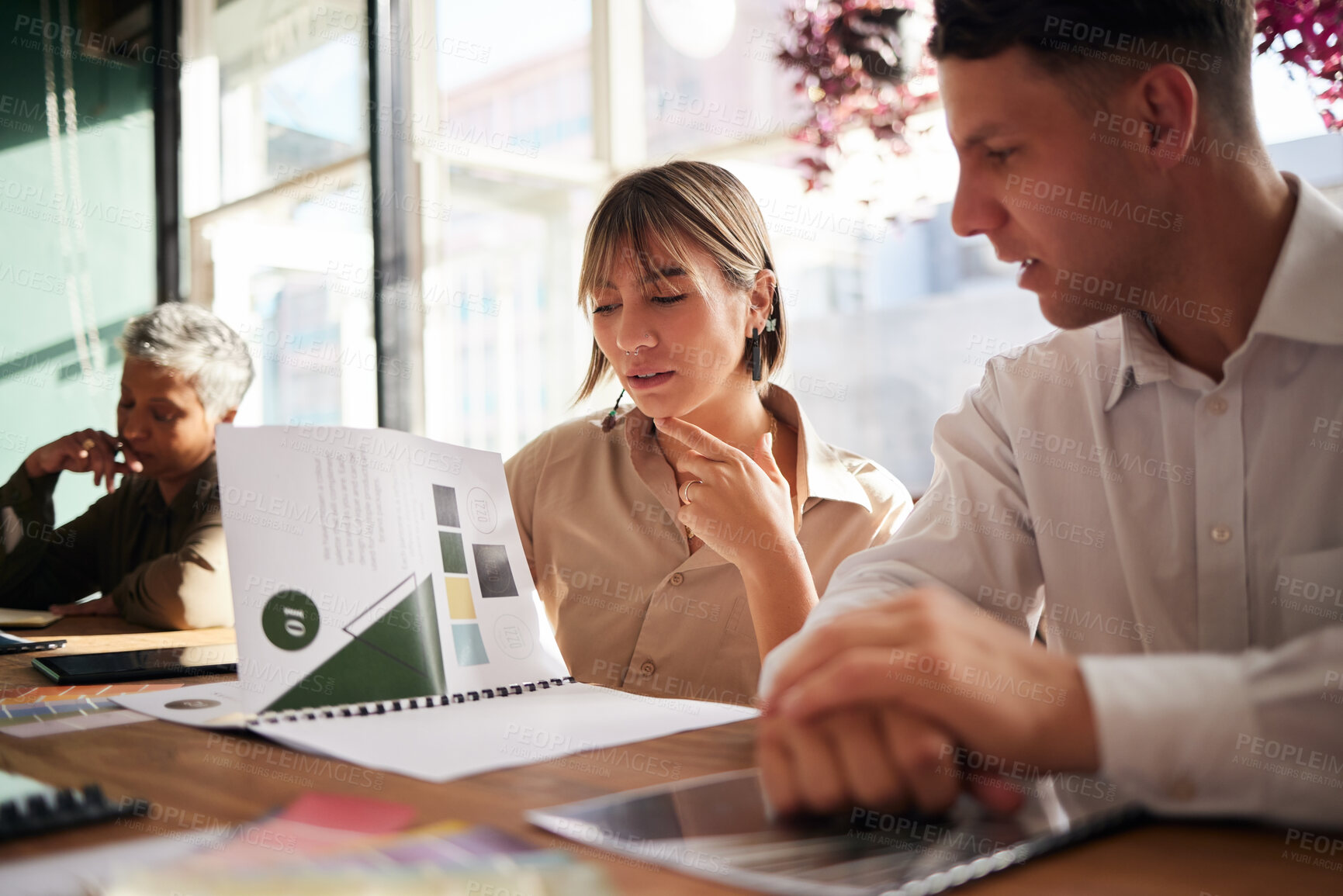 Buy stock photo Documents, woman or businessman in meeting reading a portfolio for project planning together in office. Team collaboration, paperwork or focused people thinking about design ideas or group strategy  