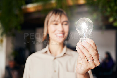 Buy stock photo Lightbulb, happy and a woman with light from inspiration, knowledge or ideas at work. Smile, innovation and an employee with power, creativity and energy at a company with optimism and vision