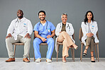 Hospital, doctor and portrait of team on chair on wall background for insurance, wellness and medical care. Healthcare, teamwork and men and women sitting in line for consulting, help and service