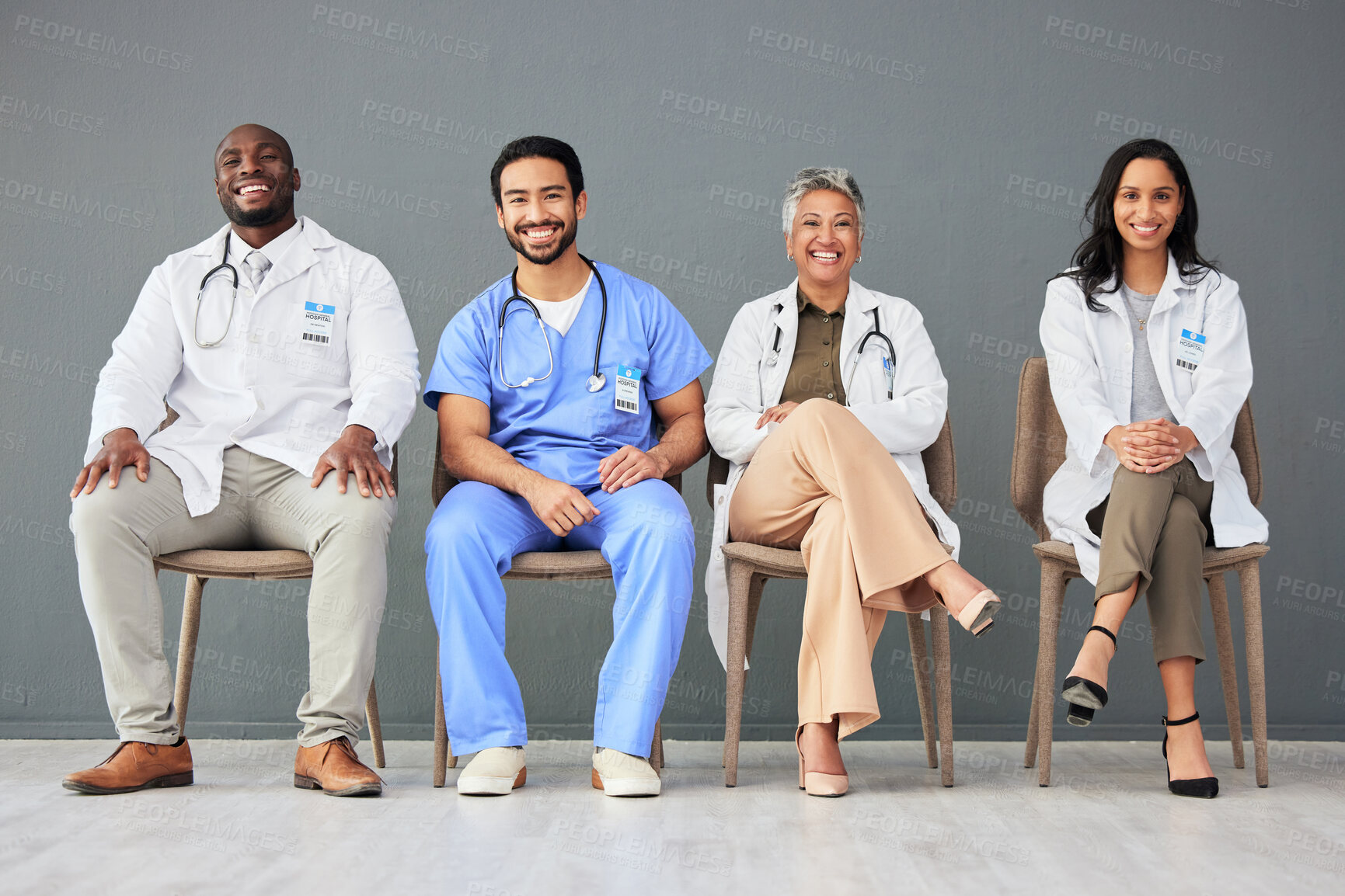 Buy stock photo Hospital, doctor and portrait of group on chair on wall background for insurance, wellness and medical care. Healthcare, teamwork and men and women sitting in line for consulting, support and service