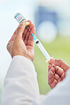 Vaccine vial, needle and hands of doctor in a medicare hospital getting ready for a monkeypox treatment. Healthcare, injection and closeup of a medical worker with a virus vaccination in a clinic.