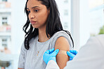 Scared woman, arm and covid with a plaster and doctor for healthcare and medical injection on arm. Female patient at a clinic or hospital for a vaccine with a bandage for virus, health and wellness