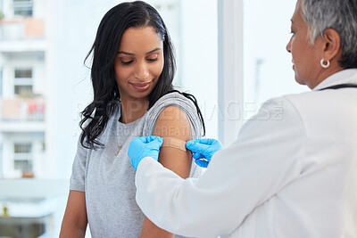 Buy stock photo Healthcare, woman and doctor with plaster, vaccination and consultation in a hospital, cure and disease. Female patient, client and medical professional with care, vaccine and injection for safety 