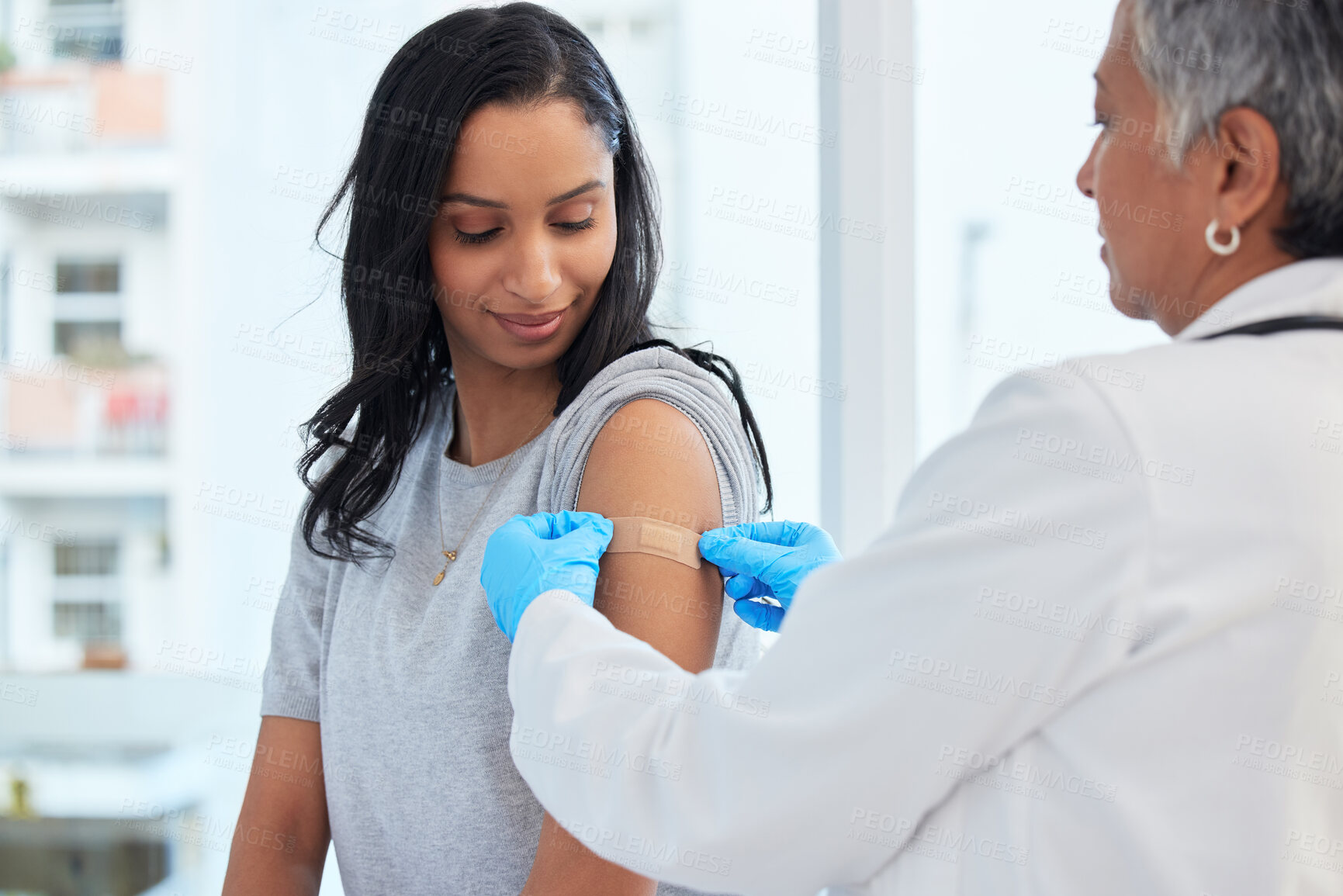 Buy stock photo Healthcare, woman and doctor with plaster, vaccination and consultation in a hospital, cure and disease. Female patient, client and medical professional with care, vaccine and injection for safety 