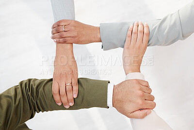 Buy stock photo Business people, hands together and unity in teamwork, collaboration or meeting for community trust above at office. Hand of group employee touching arms in team building, agreement or coordination