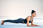 Fitness, woman and stretching or plank in workout, exercise or training at gym on mockup. Serious, sporty and fit female exercising for healthy wellness or body stretch on floor with copy space