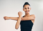 Fitness, portrait and woman arm stretch in studio for yoga, exercise and training on grey background. Pilates, stretching and face of female personal trainer at sports center for wellness or workout