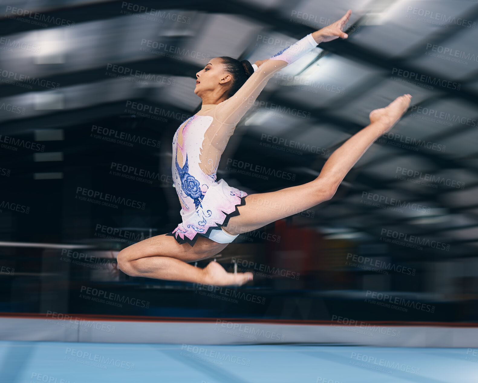 Buy stock photo Woman, gymnastics and jump in motion blur for performance, flexible skill and dancer. Female, rhythmic movement and stretching body mid air for action, creative talent and agility training in arena