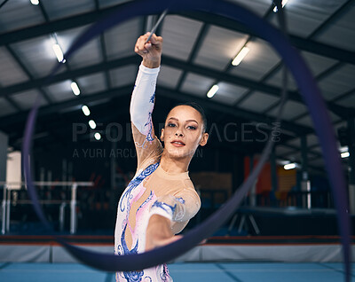 Ribbon, gymnastics and portrait of woman in action, dance performance and sports competition. Female, rhythmic movement and dancing athlete with creative talent, concert event and practice arena