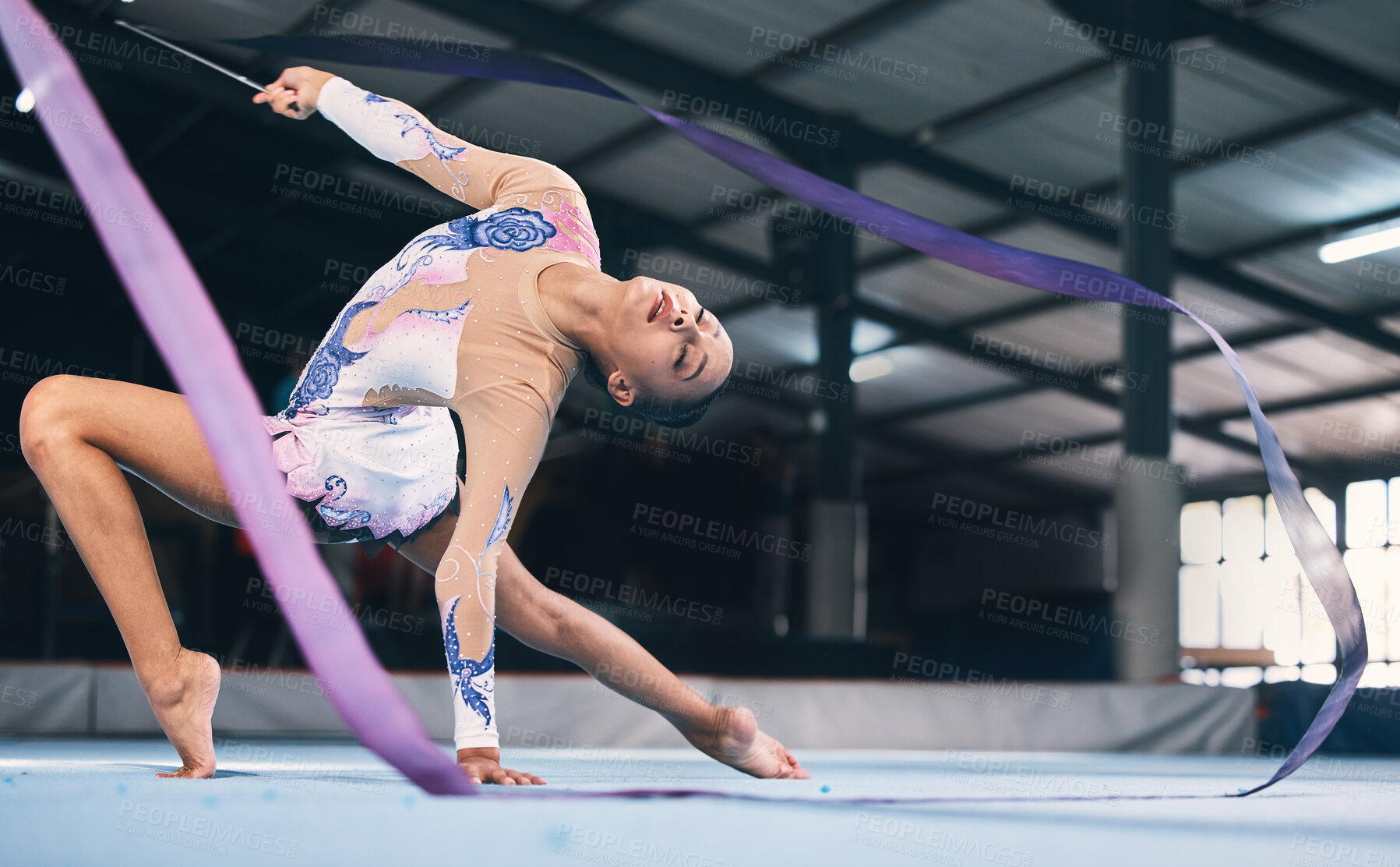 Buy stock photo Ribbon, gymnastics and flexible woman stretching in performance, dance training and sports competition. Female, rhythmic movement and dancing athlete for creative skill, talent and concert in arena 