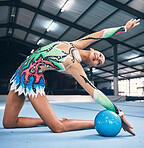 Flexible woman, gymnastics and ball for performance, competition training and dancing in sports arena. Female, rhythmic movement and dancer in creative talent, solo concert and stretching for agility