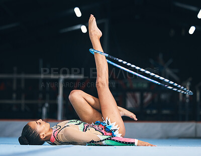 Woman, gymnastics and spinning hoop on leg for competition, sports training  and action in arena. Female dancer, rhythmic movement and athlete with loop  for creative solo concert, event or performance