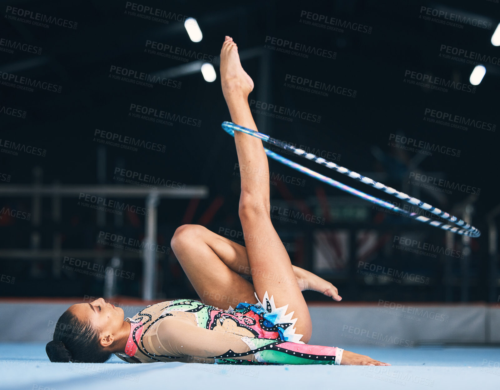 Buy stock photo Woman, gymnastics and spinning hoop on leg for competition, sports training and action in arena. Female dancer, rhythmic movement and athlete with loop for creative solo concert, event or performance