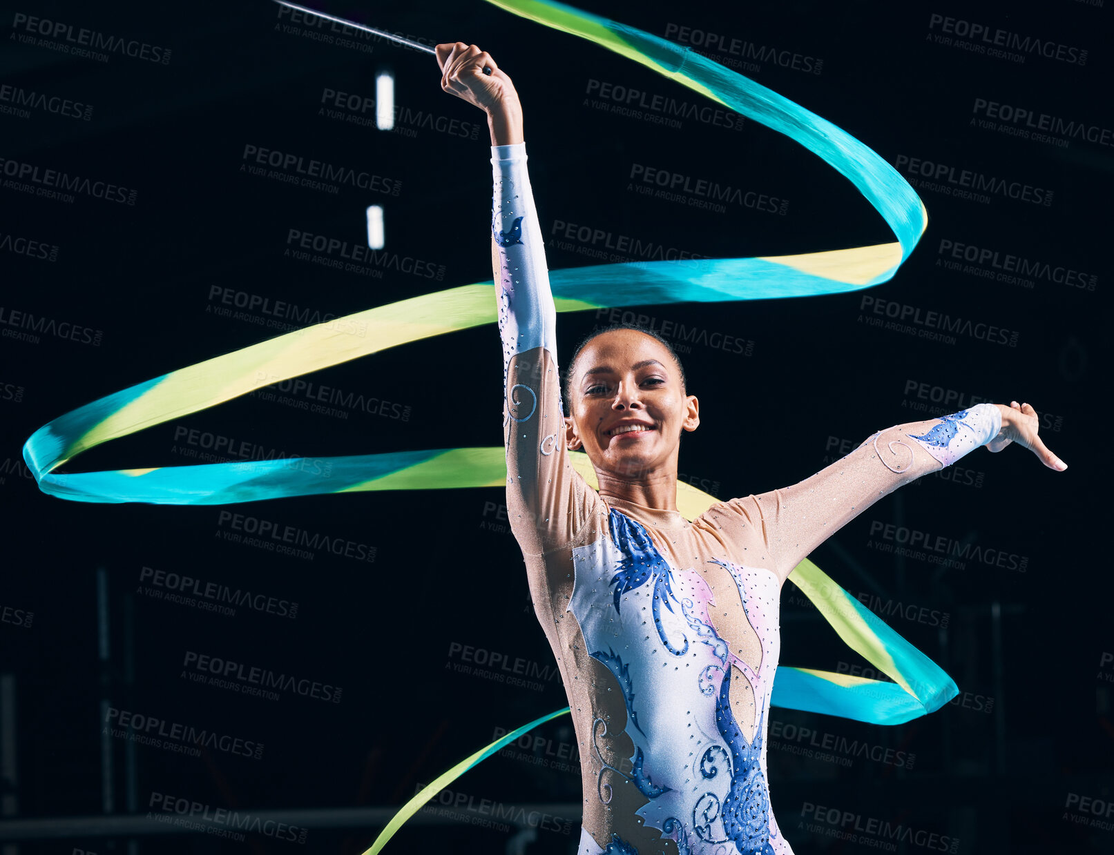 Buy stock photo Ribbon gymnastics, happy woman and portrait of dancer in performance, training show and competition in dark arena. Female, rhythmic movement and smile for action, creative talent and sports concert 