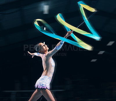 Buy stock photo Ribbon gymnastics, woman and smile in motion blur of dancer, talent show and competition in dark arena. Happy female athlete, rhythmic movement and dancing for action, creative sports and performance