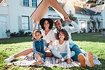 Cardboard roof, portrait and family relax on the lawn of new home, property or real estate, happy and excited. House, gesture and face of kids with parents relax on grass, proud and mortgage success