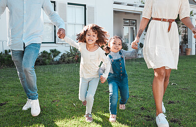 Buy stock photo Family, holding hands and kids running with their parents outdoor in the garden of their home together. Children, fun and daughter siblings playing with their mother and father outside in the yard