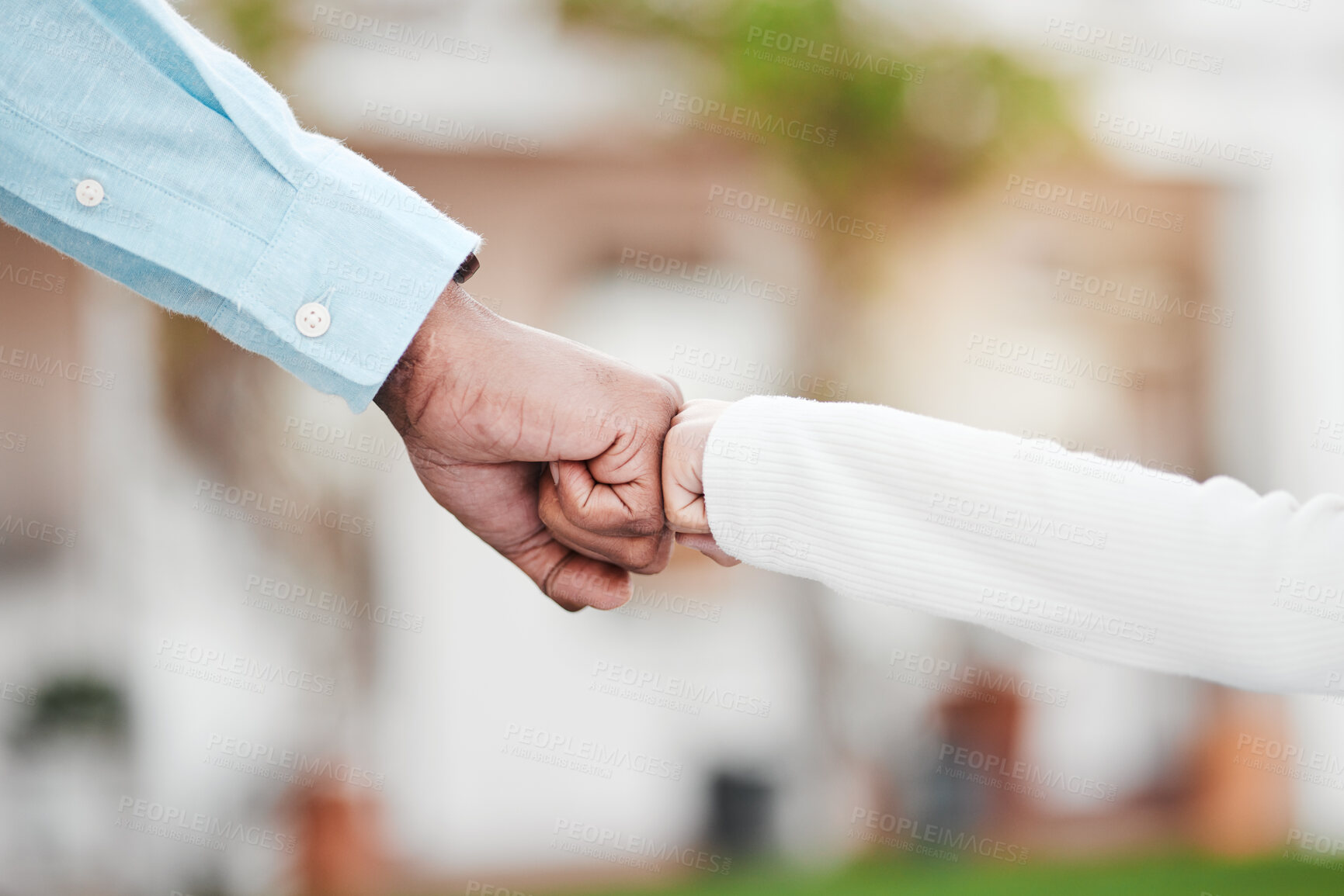 Buy stock photo Adult, child and hands in fist bump for trust, agreement or partnership in generations against a blurred background. Big and small hand bumping fists for support, collaboration or teamwork and growth