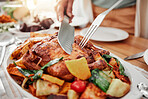 Food, roast chicken dinner and party, table setting and celebration and holiday with Christmas or thanksgiving. Social event, closeup and carve protein with knife, gourmet meal and festive feast