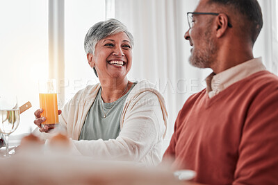 Buy stock photo Happy, elderly and a couple talking at breakfast, laughing at a joke and enjoying juice together. Smile, morning and a senior man and woman enjoying a lunch while speaking and bonding at home