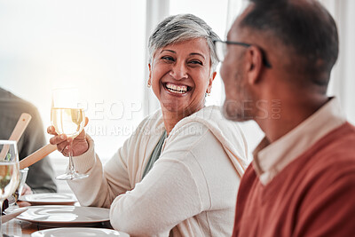 Buy stock photo Happy, smile and couple at lunch in family home, drinking wine and laughing at jokes. Conversation, together and a man and woman speaking with a drink during a dinner with friends in a house