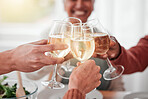 People, hands and cheers for happy dinner, fine dining or celebration for meal or friendship together. Hand of family or friends toasting by table for food, drink or bonding in celebration at home