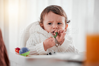 Buy stock photo Baby, angry child and eating vegetables in home for health, wellness and nutrition. Upset kid, high chair and food, veggies or breakfast in kitchen for healthy diet, growth and development in house.