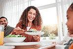 Family dinner, happy woman and salad with children at home for nutrition. Celebration, together and people with kids eating at table with happiness and a smile in a house giving lunch on plate