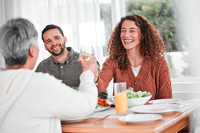 Buy stock photo Family dinner, couple and cheers of a happy woman with healthy food in a home. Celebration, together and people with unity from eating at table with happiness and a smile in a house with toast