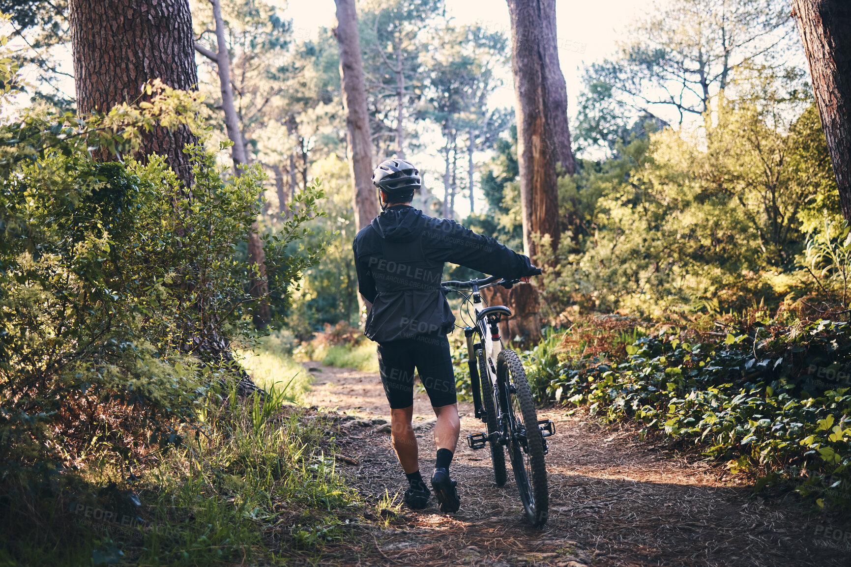 Buy stock photo Nature, fitness and man cyclist with a bicycle for cardio training, health or wellness in the woods. Sports, cycle and male athlete walking with a bike outdoor in the forest to practice for a race.