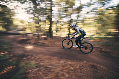 Buy stock photo Bicycle, mountain bike and man cycling in the forest or woods fast, speed and adrenaline with motion blur. Extreme sports, actions and rider cycling for exercise, fitness and workout in nature