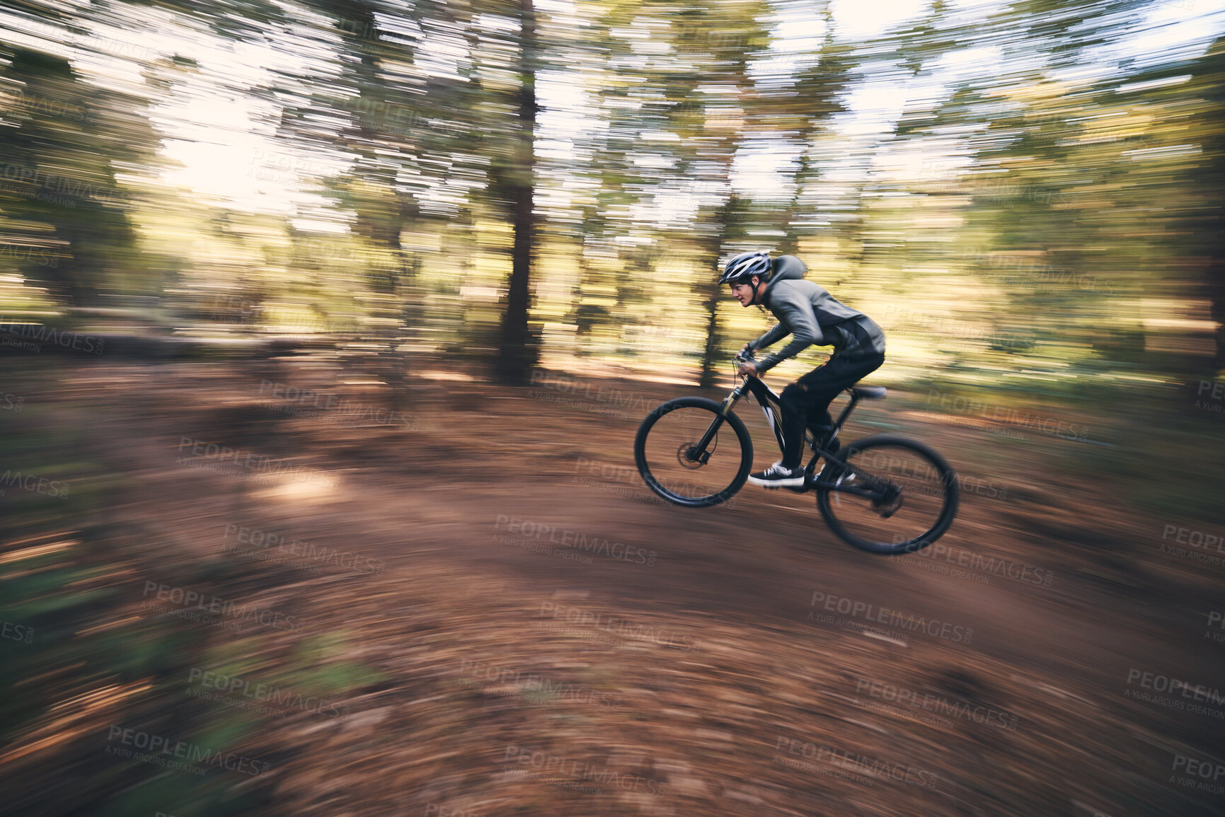 Buy stock photo Bicycle, mountain bike and man cycling in the forest or woods fast, speed and adrenaline with motion blur. Extreme sports, actions and rider cycling for exercise, fitness and workout in nature