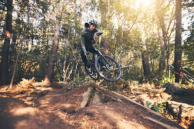 Buy stock photo Cycling trick, speed and man on a bicycle on a dirt forest road doing training and exercise on a bike. Fast, outdoor trail and biker athlete with cardio and energy on a biking adventure with jump