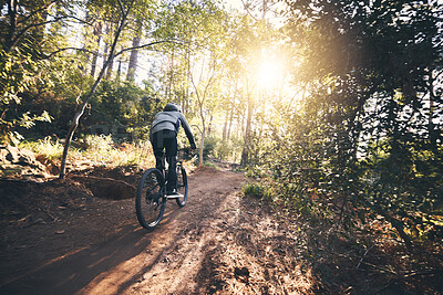 Buy stock photo Cycling, nature and fitness with man on path for training, workout or cardio exercise. Adventure, extreme sports and speed with male cyclist on bike in forest park for performance, challenge or break