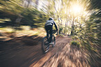 Energy, cycling, and speed with man in nature for training, extreme sports and motion blur. Workout, race and fast with cyclist on bike in forest park for performance, challenge and adventure