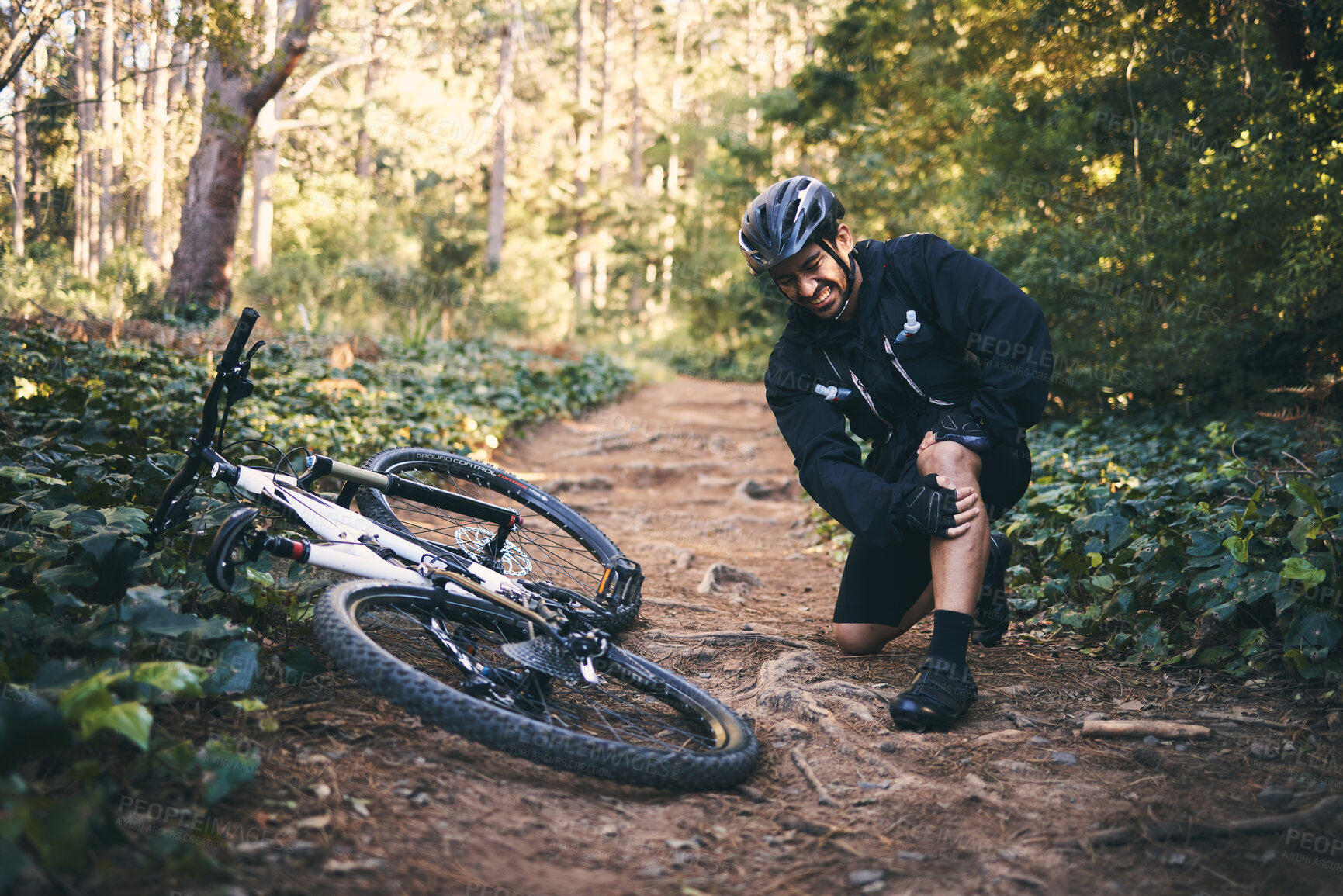 Buy stock photo Sports man, injury and leg pain outdoor while cycling on mountain bike with nature trees and dirt. Athlete person on ground in forest for fitness exercise, training or workout accident, crash or fall