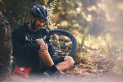 Buy stock photo Man, cycling and outdoor with leg or knee injury in nature for sports, exercise or training on mountain bike. Athlete person with bicycle and first aid for fitness workout accident or fall in forest
