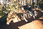 Fitness, bicycle hill and man outdoor on a forest path with extreme and exercise adventure. Bike, cycling and sport of an athlete with fast speed and nature cycle for sports training and race action