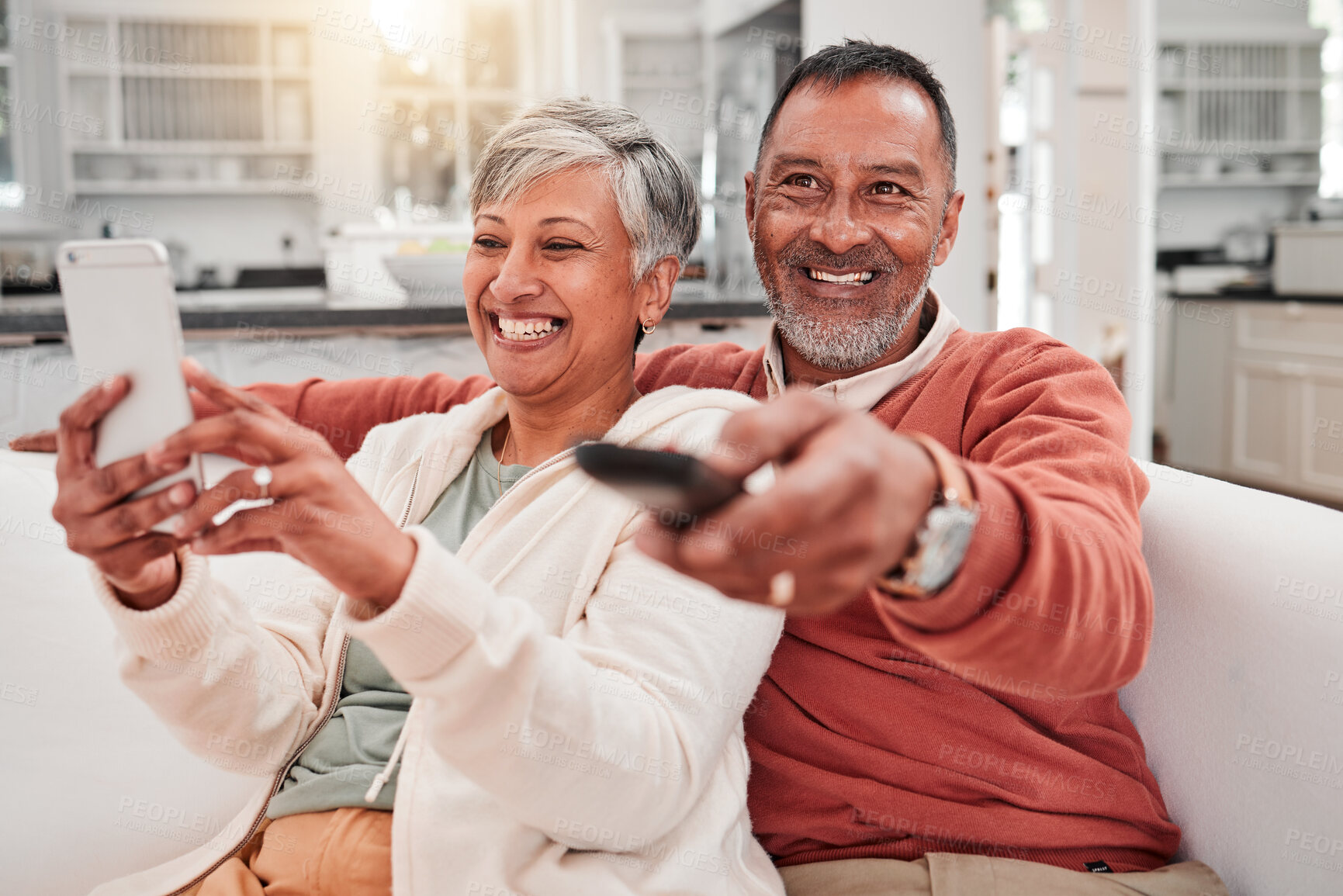 Buy stock photo Watching tv, phone and happy couple in home living room, bonding and having fun. Cellphone, television and elderly man and woman enjoying retirement, smile and streaming movie, video or film on sofa.