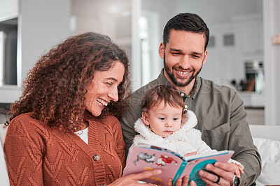 Buy stock photo Parents, baby and reading story on sofa with smile, happiness and bonding with love in living room. Man, woman and child with book for learning, care and relax together on lounge couch in family home